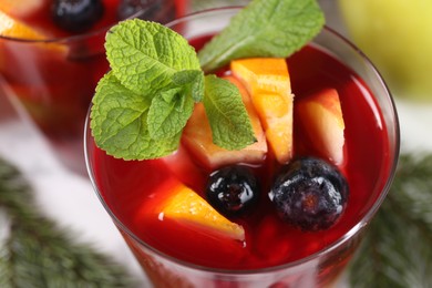 Photo of Aromatic Sangria drink in glass on table, closeup