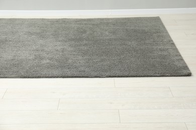 Photo of Soft grey carpet on white laminated floor indoors