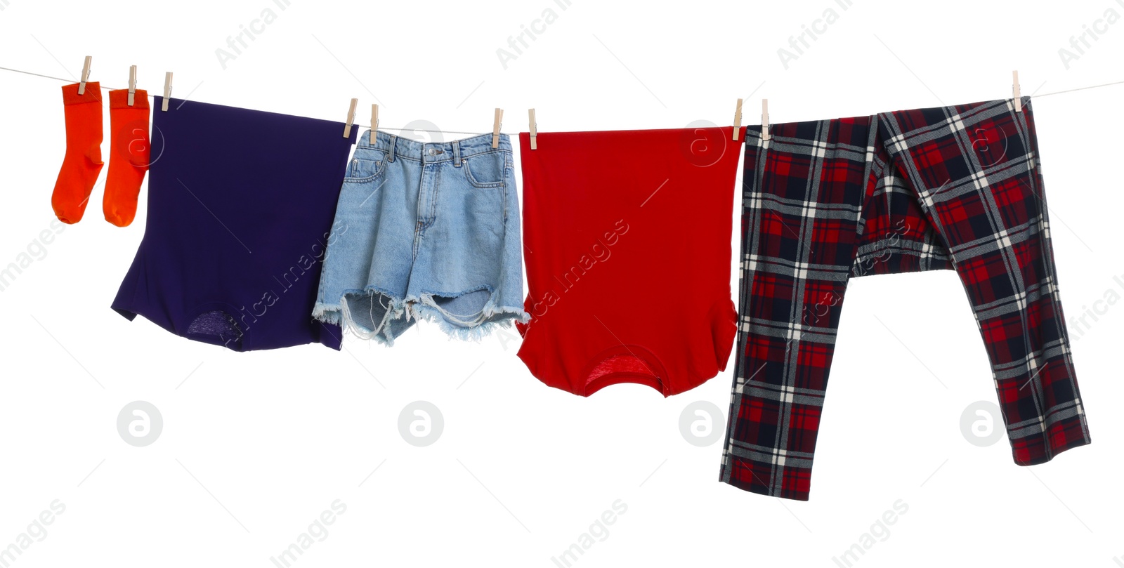 Photo of Different clothes drying on laundry line against white background