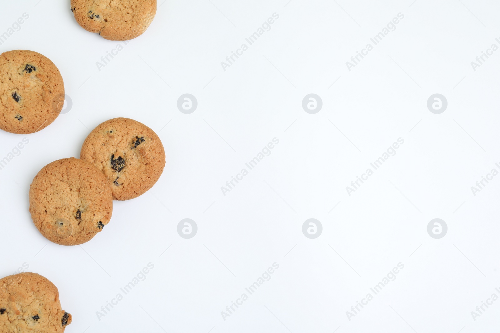 Photo of Tasty homemade cookies with raisins on white background, top view