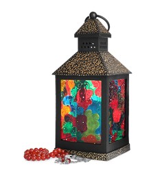 Photo of Decorative Arabic lantern and misbaha on white background