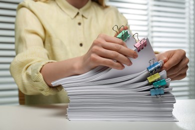 Photo of Woman working with documents at table in office, closeup