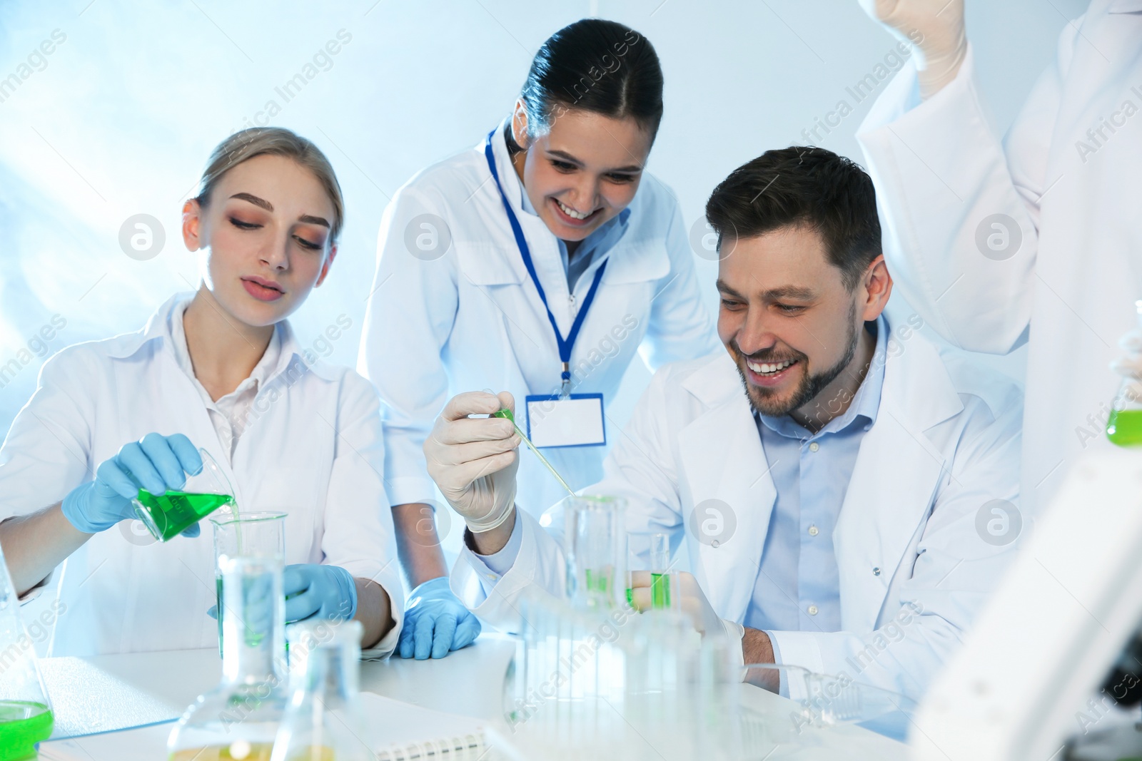 Photo of Group of scientists working in modern chemistry laboratory