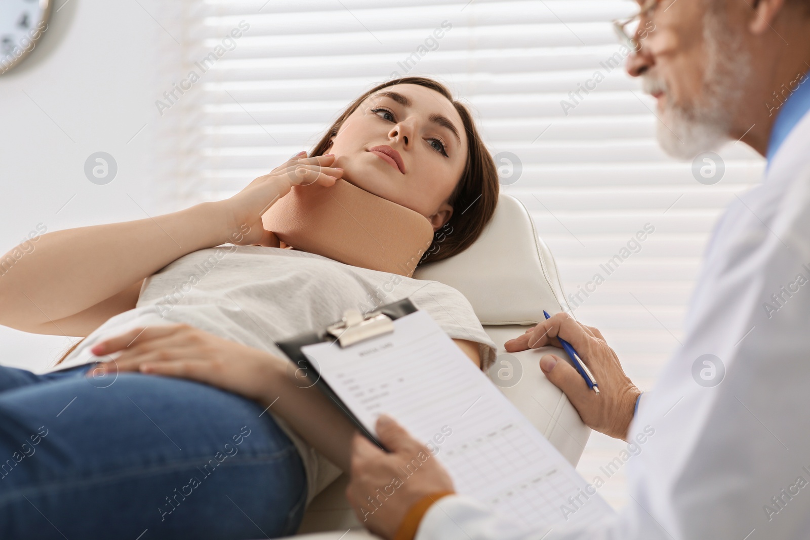 Photo of Doctor filling patient's medical card in clinic, closeup