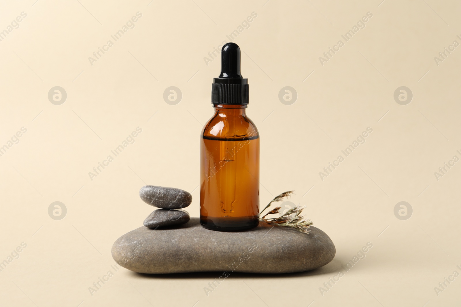 Photo of Composition with bottle of cosmetic serum on beige background