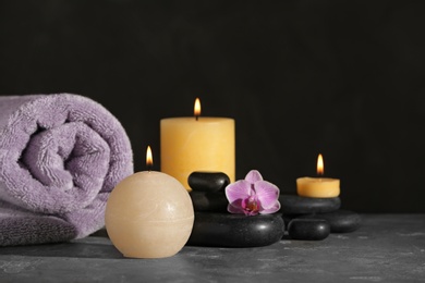 Composition with candles and spa stones on grey table