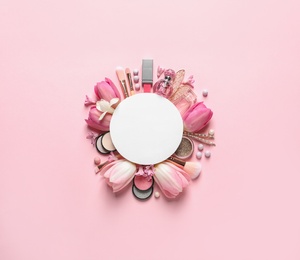 Photo of Makeup products, spring flowers and blank card on color background, flat lay. Space for text
