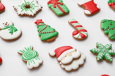 Photo of Different Christmas gingerbread cookies on white background, closeup