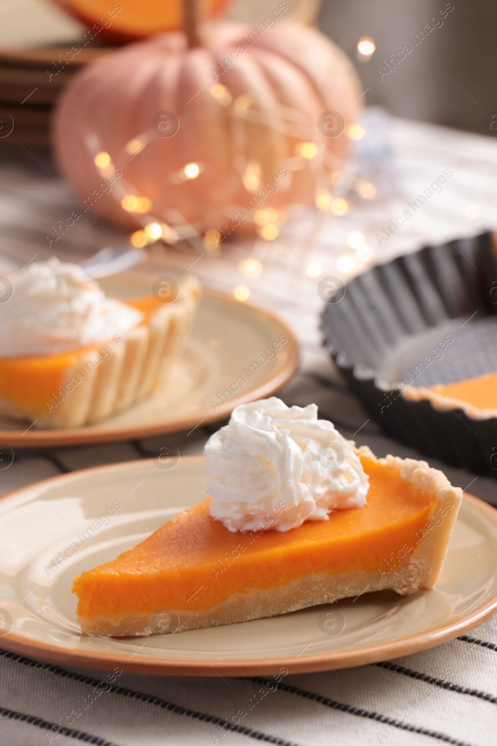 Photo of Fresh homemade pumpkin pie with whipped cream on table