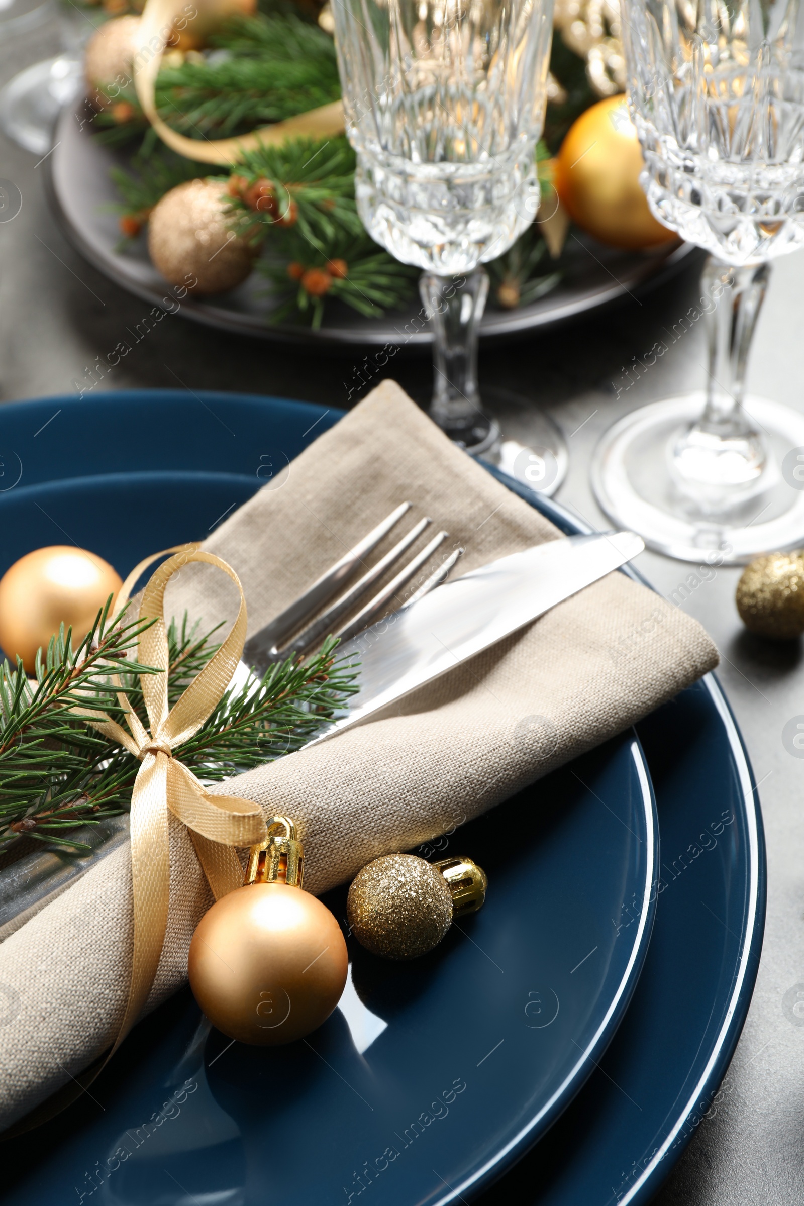 Photo of Festive table setting with beautiful dishware and Christmas decor on grey background