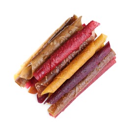 Delicious fruit leather rolls on white background, top view