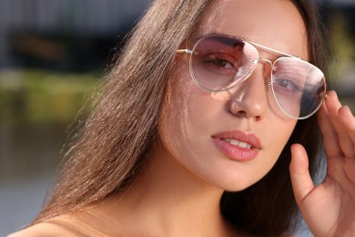 Beautiful woman in sunglasses outdoors on sunny day