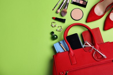 Photo of Flat lay composition with stylish woman's bag on light green background. Space for text