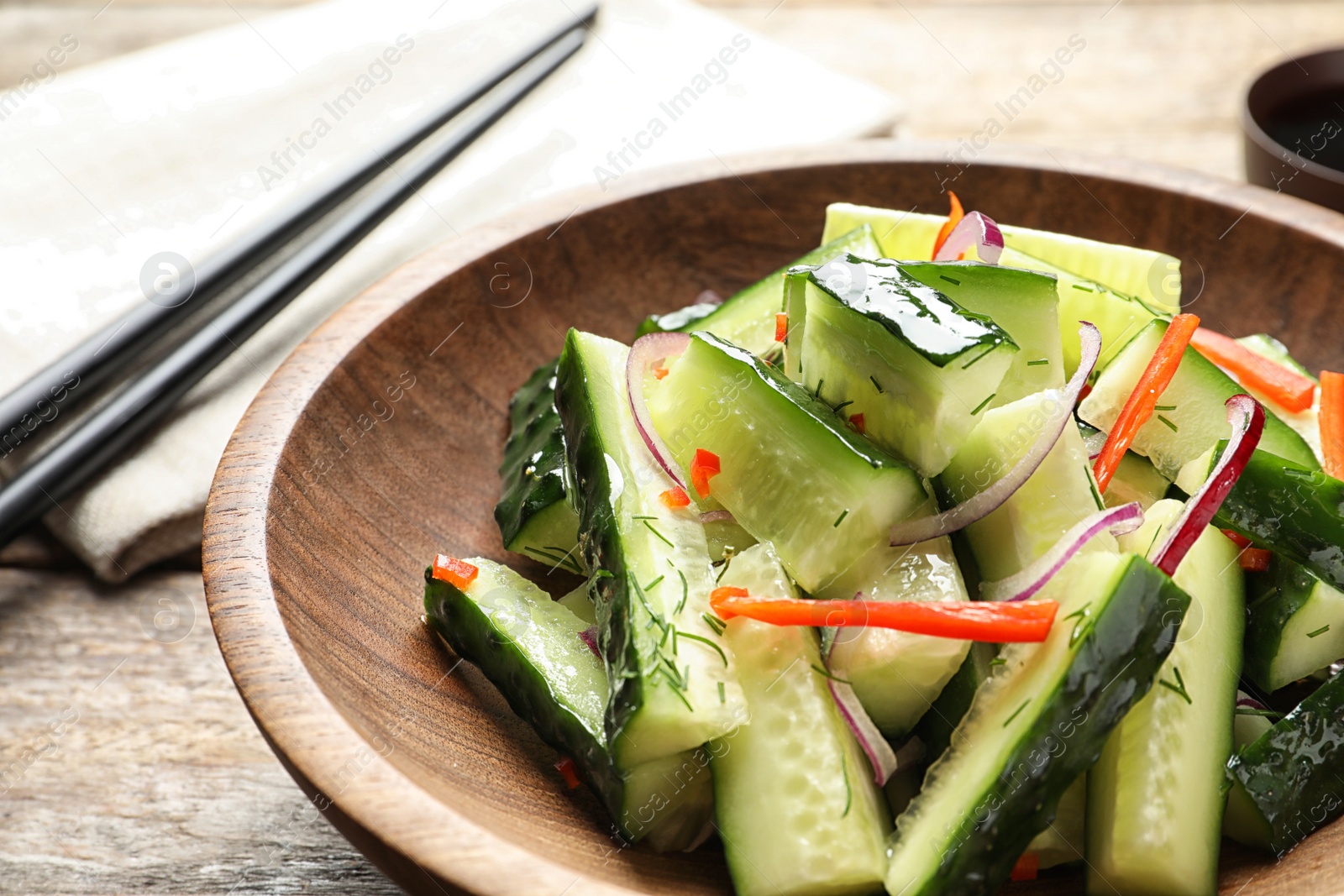 Photo of Plate with delicious cucumber salad on table, closeup