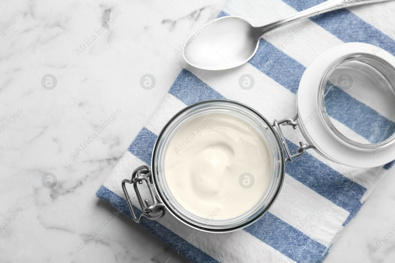 Photo of Jar with yummy yogurt on table