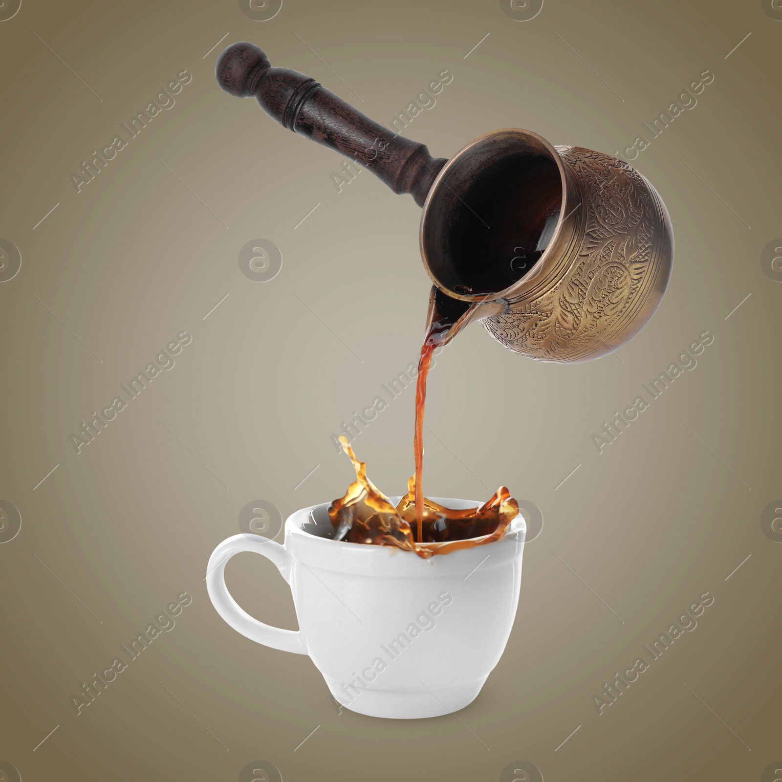 Image of Pouring freshly brewed aromatic coffee from turkish pot into cup. Objects in air on dark beige background