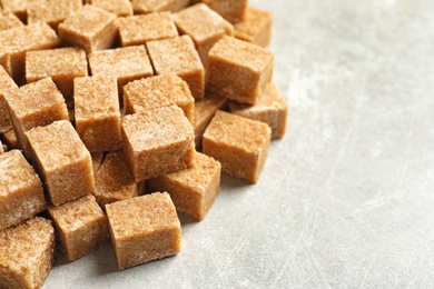 Cubes of brown sugar on gray table