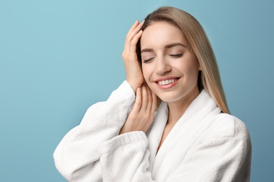 Photo of Beautiful young woman with silky skin on color background