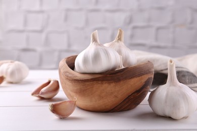 Photo of Fresh garlic on white wooden table, closeup