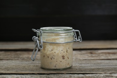Photo of Leaven in glass jar on wooden table