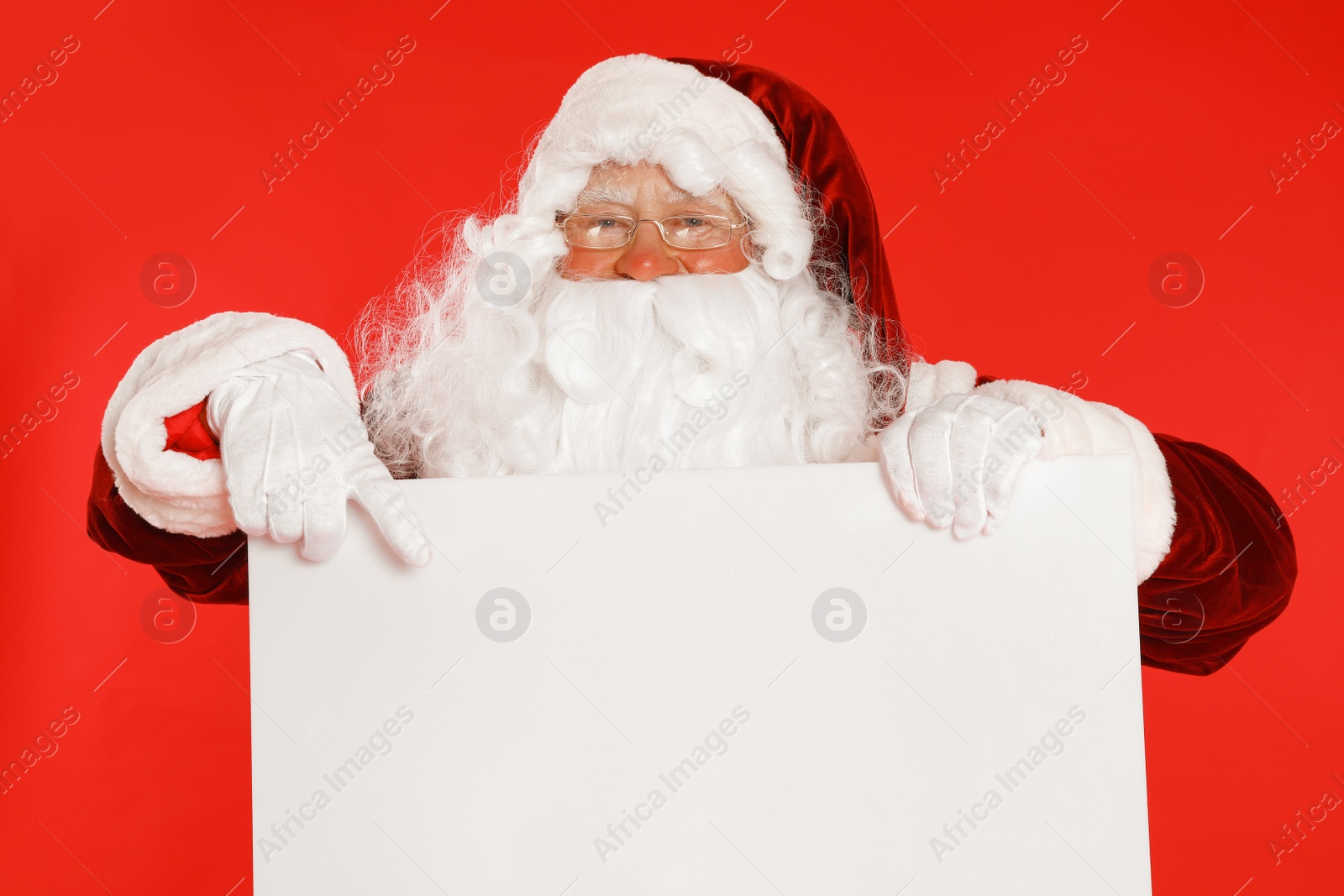 Photo of Authentic Santa Claus with blank banner on red background. Space for design