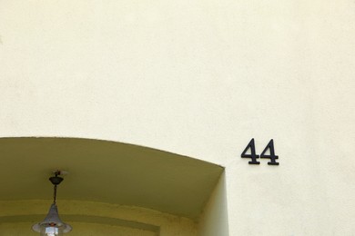 Photo of House number 44 on beautiful building outdoors. Space for text