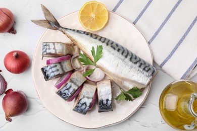 Tasty salted mackerel, parsley, onion and lemon on white textured table, flat lay