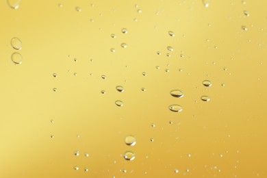 Many serum drops on mirror, toned in yellow