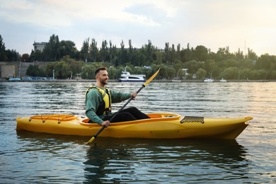 Photo of Handsome man kayaking in river. Summer activity