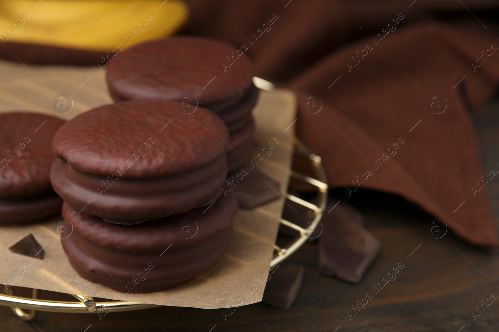 Photo of Delicious choco pies on wooden table, closeup. Space for text