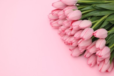 Photo of Bouquet of beautiful tulips on pink background, above view. Space for text