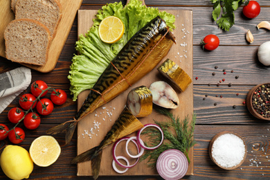 Flat lay composition with smoked fish on wooden table