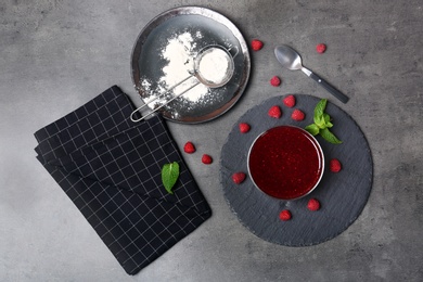 Photo of Beautiful composition with delicious raspberry jam on table, top view