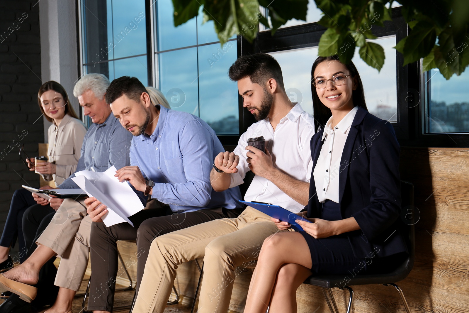 Photo of People waiting for job interview in office hall