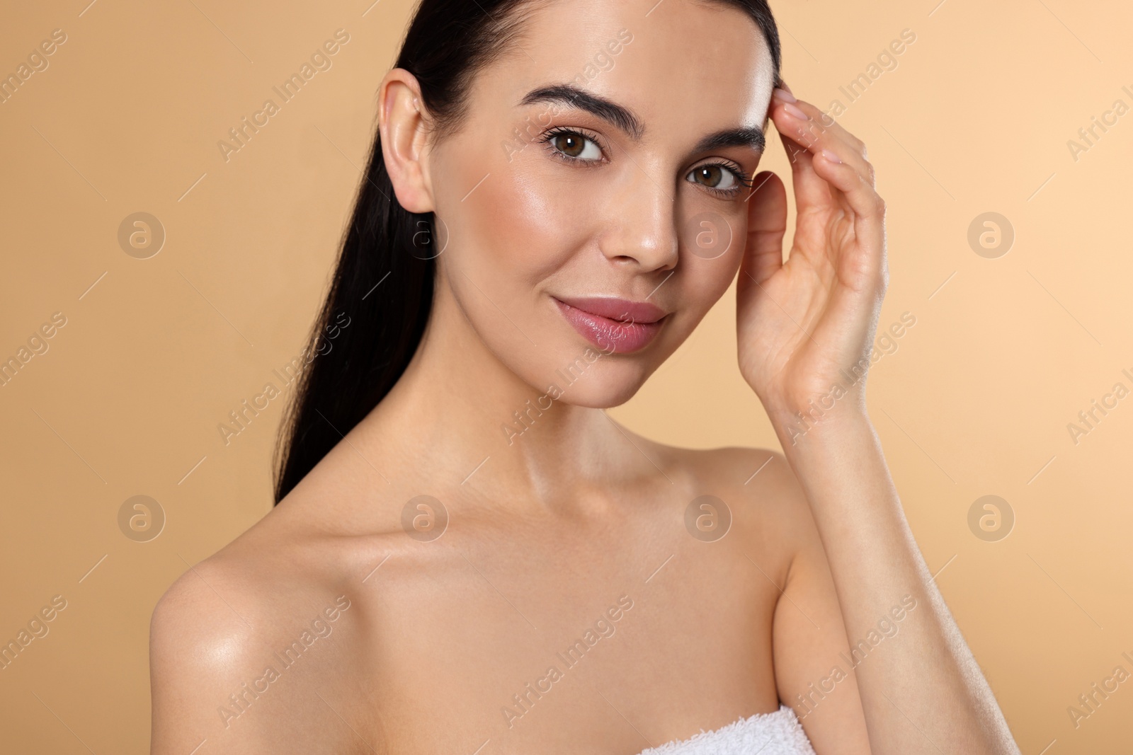 Photo of Portrait of attractive young woman on beige background. Spa treatment