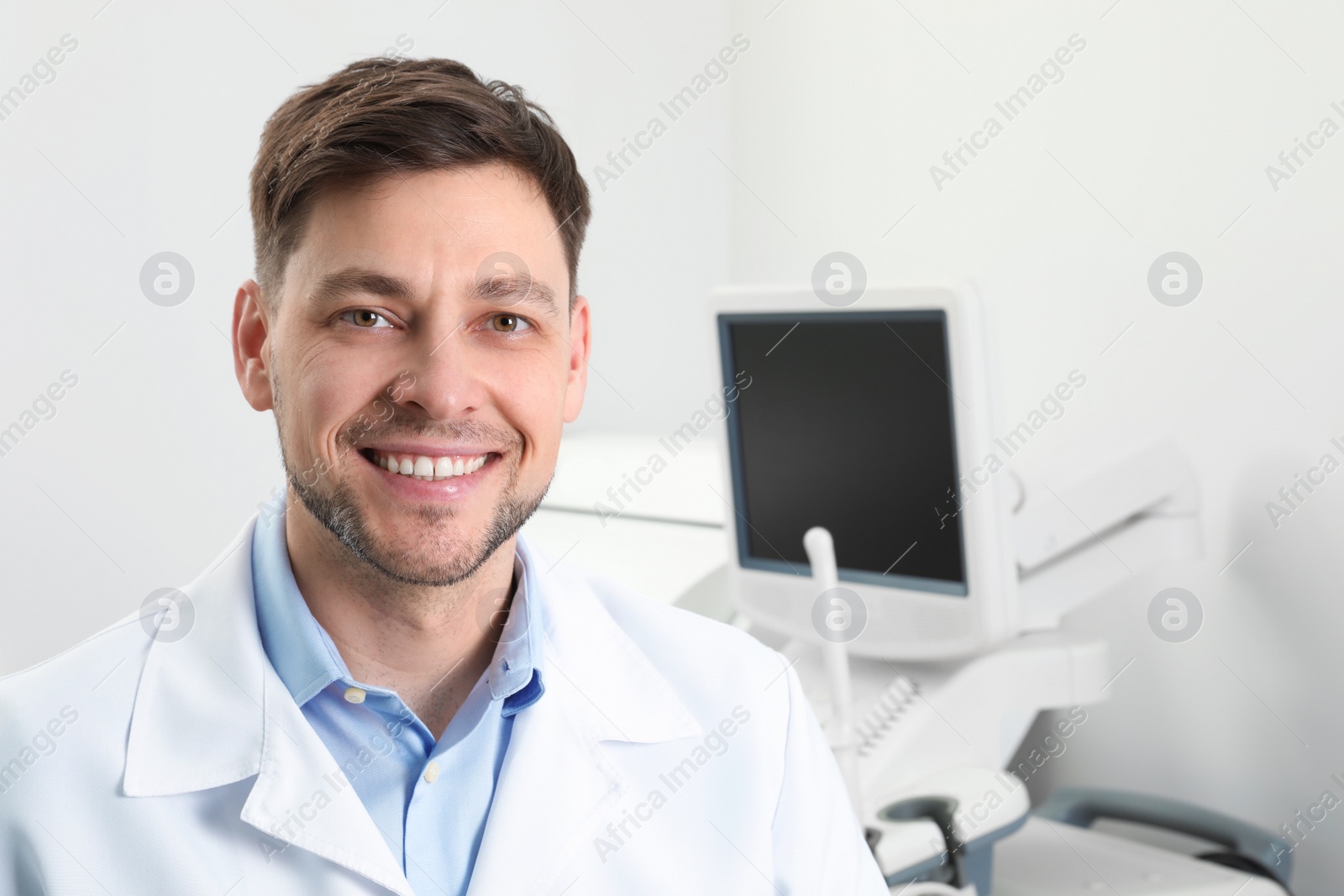 Photo of Professional sonographer near modern ultrasound machine in clinic