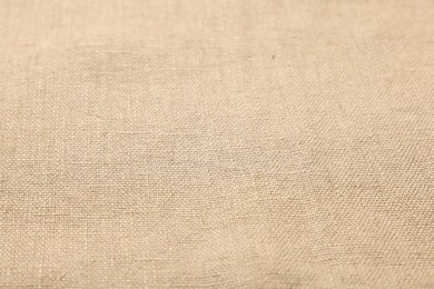 Texture of beige fabric as background, closeup