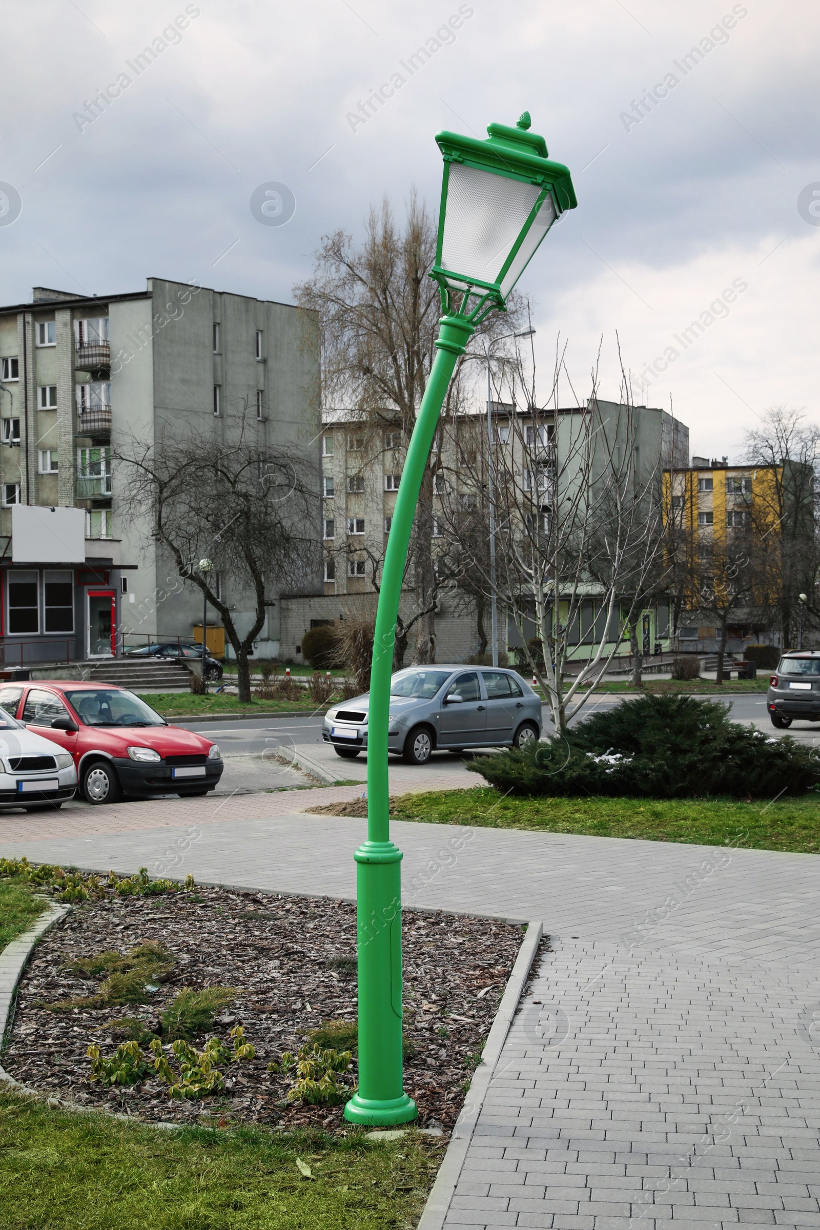 Photo of Funny green street lamp outdoors on sunny day