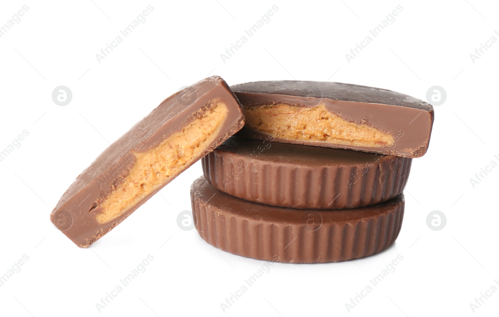 Photo of Cut and whole peanut butter cups isolated on white