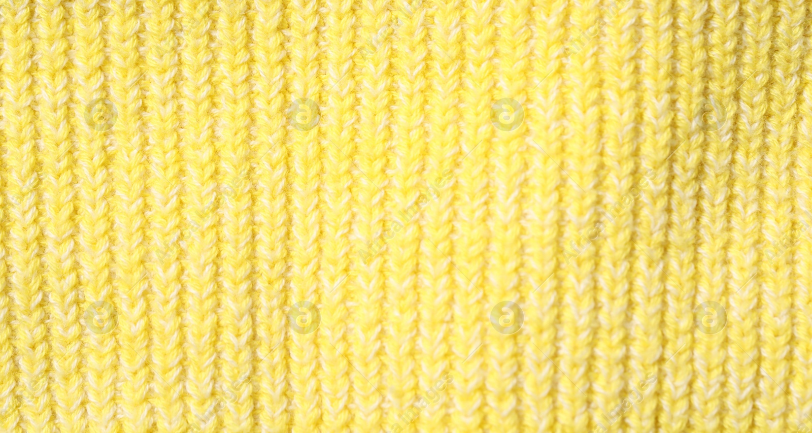 Photo of Texture of soft yellow fabric as background, top view