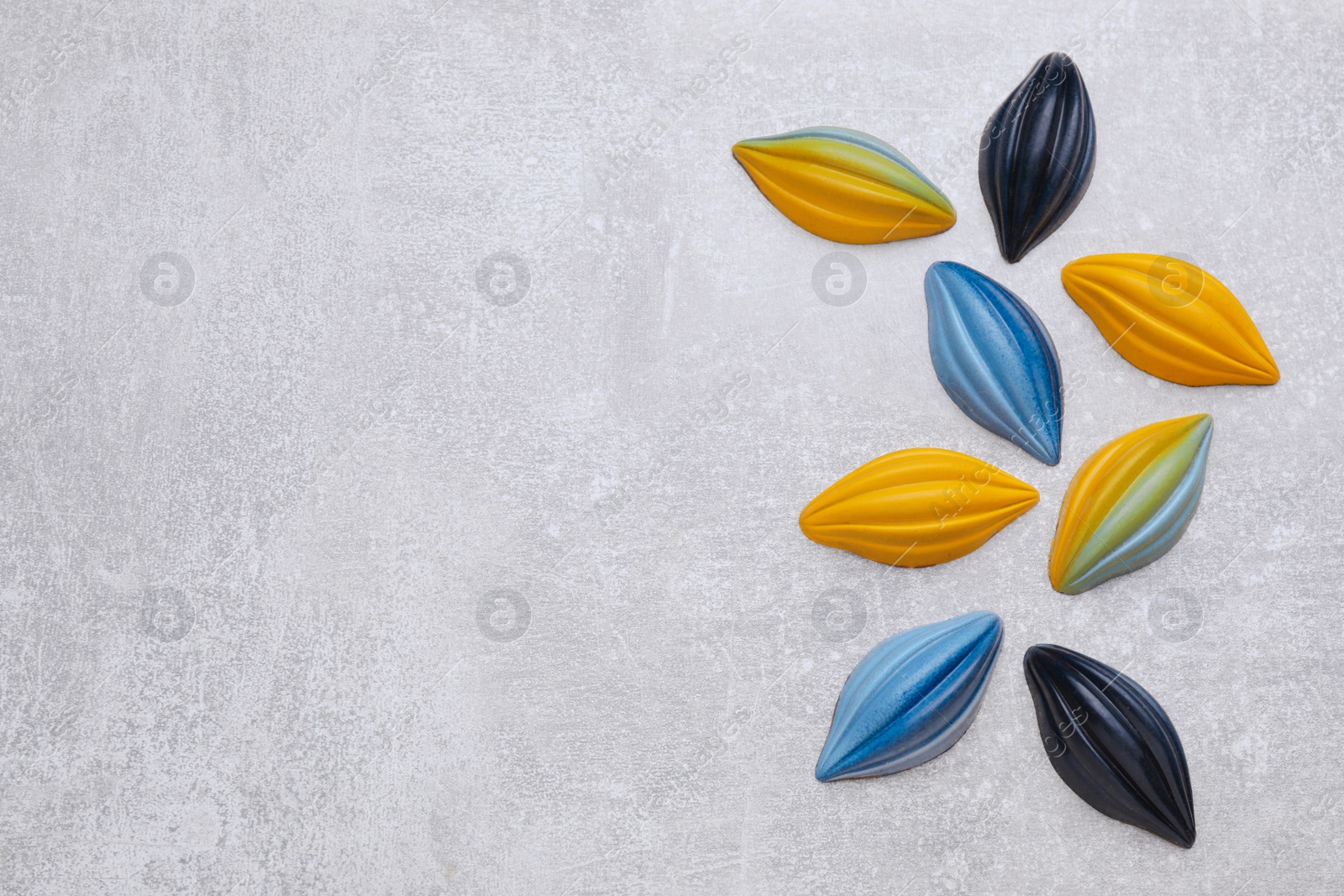 Photo of Tasty chocolate candies on light grey table, flat lay. Space for text