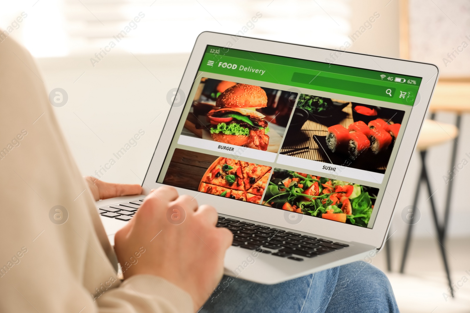 Photo of Man using laptop for ordering food online at home, closeup. Concept of delivery service