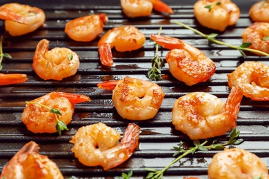 Delicious fried shrimps in grill pan, closeup