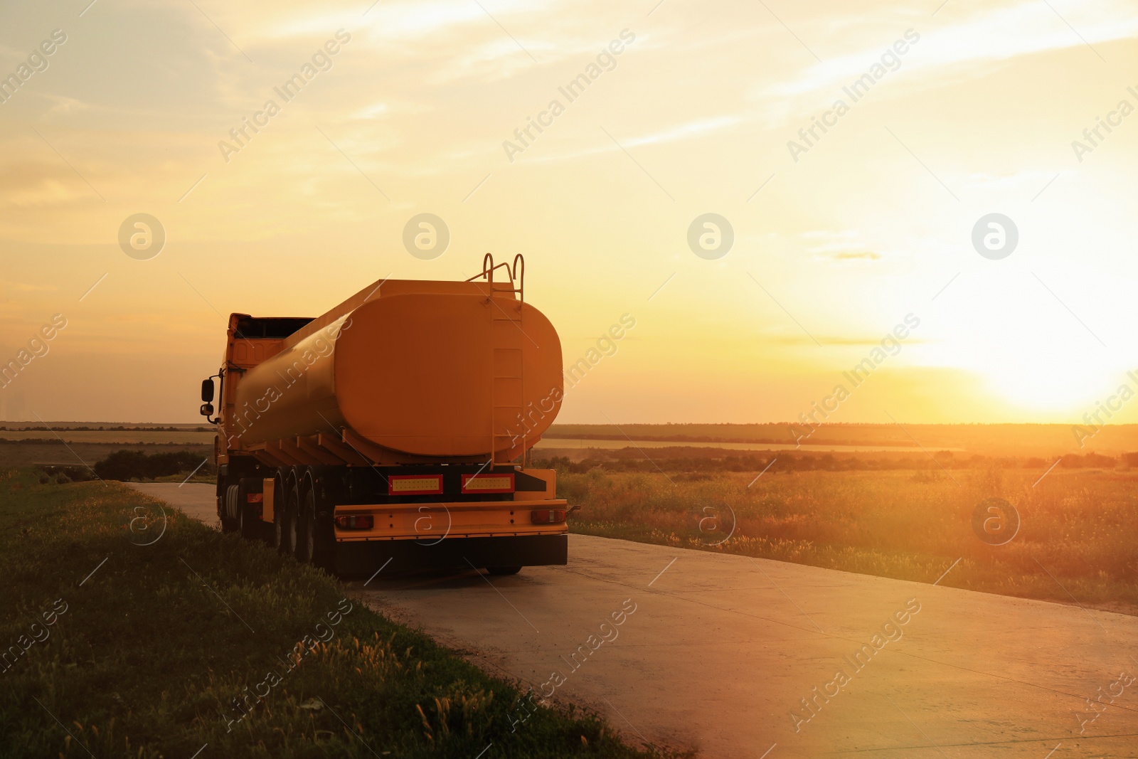 Photo of Modern bright truck on country road. Space for text