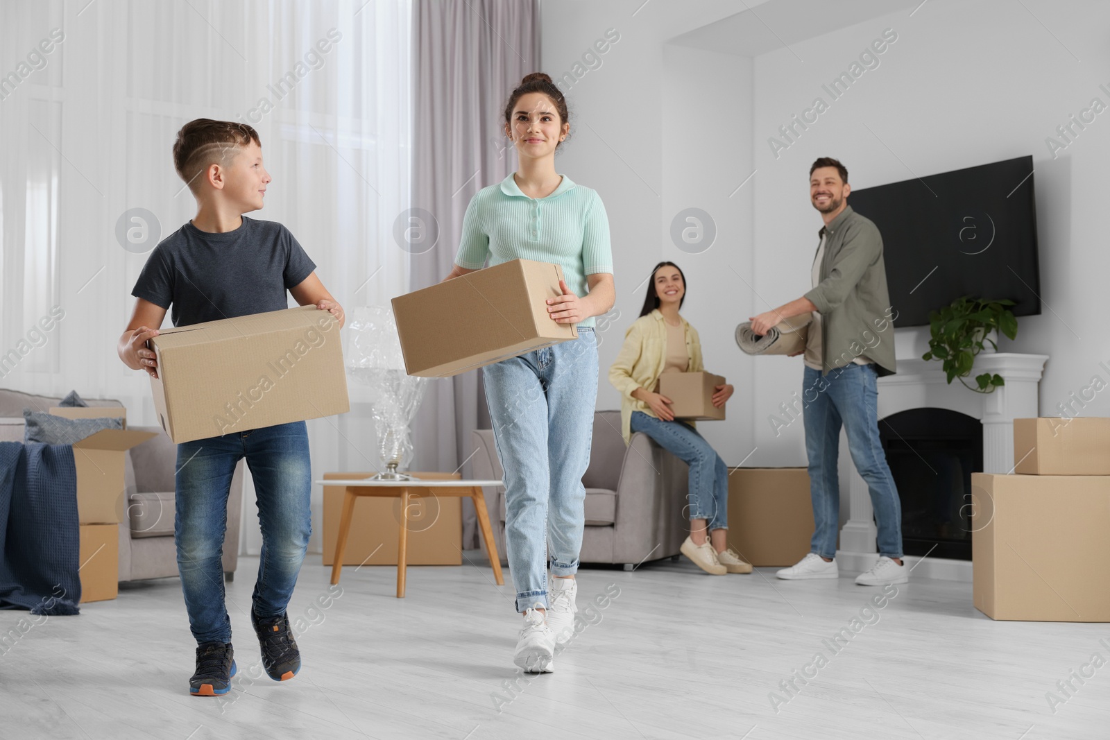 Photo of Happy family settling into new house and unpacking boxes. Moving day