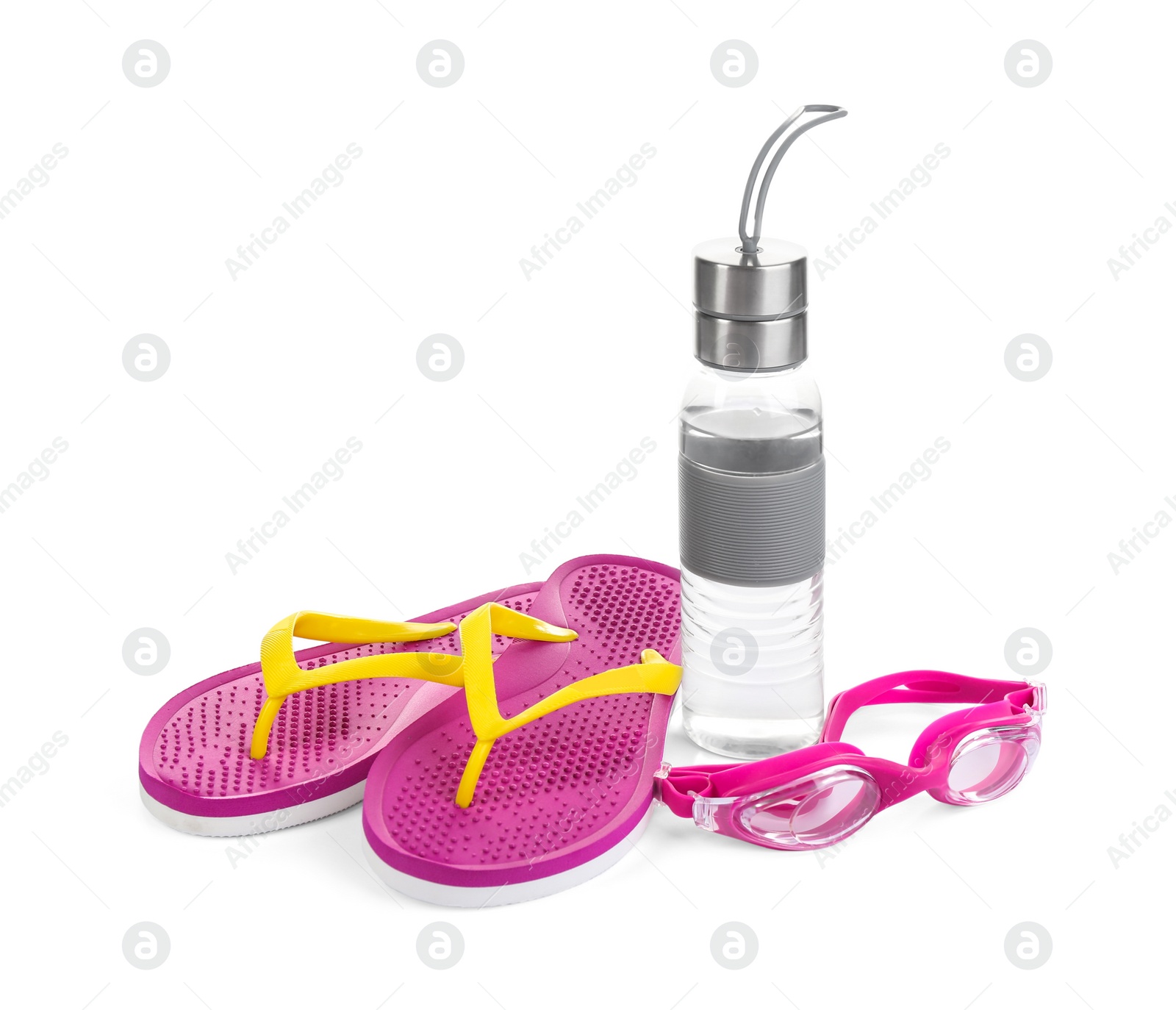 Photo of Swimming goggles, water bottle and flip flops isolated on white