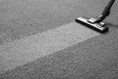 Photo of Vacuuming grey carpet. Clean area after using device. Space for text