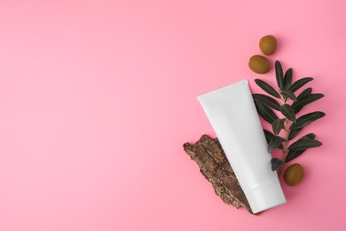Natural cosmetic. Flat lay composition with olive cream on pink background. Space for text