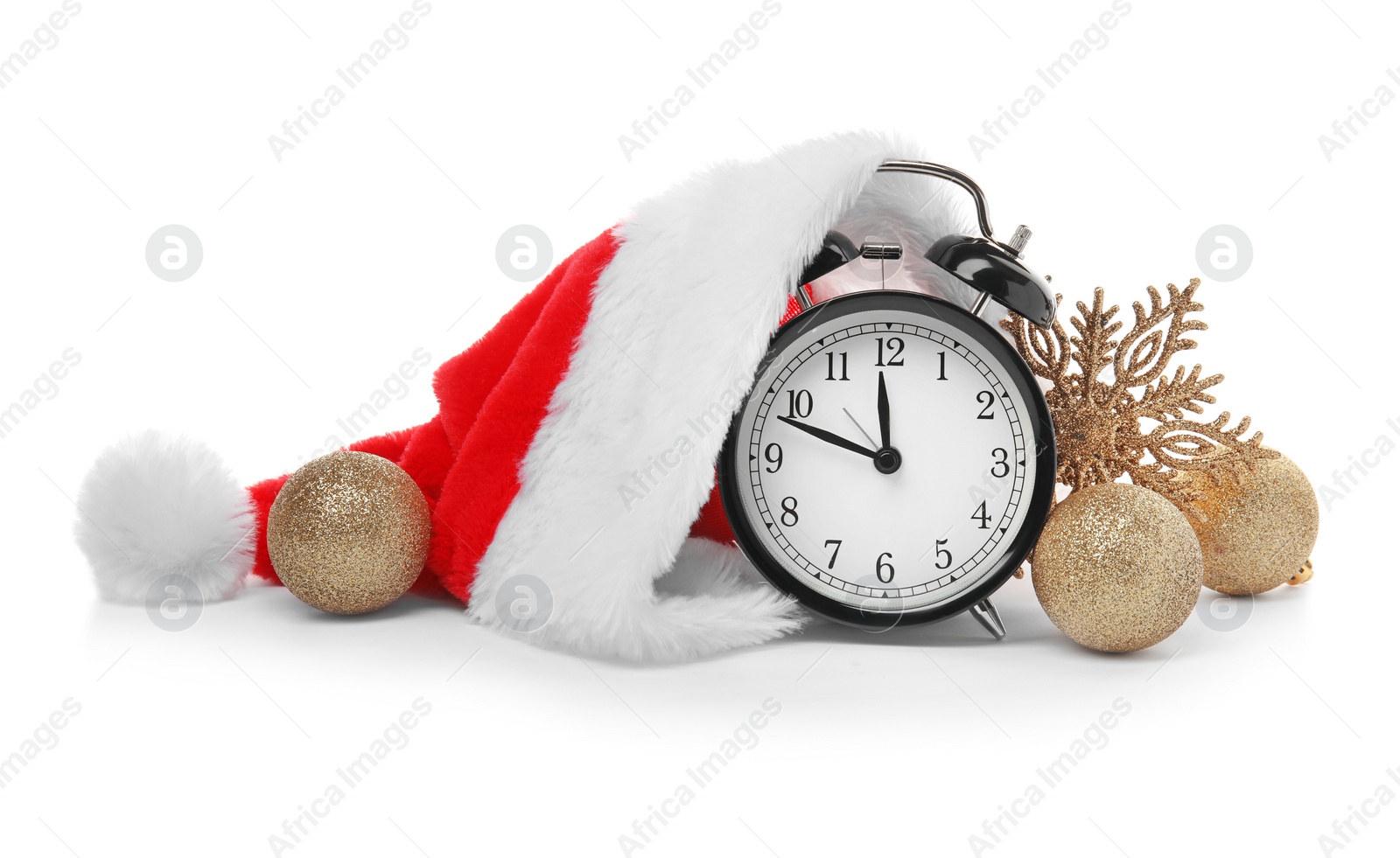 Photo of Alarm clock with Santa hat and festive decor on white background. Christmas countdown