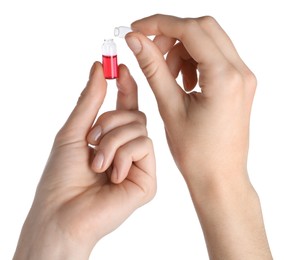 Photo of Woman opening glass ampoule with pharmaceutical product on white background, closeup